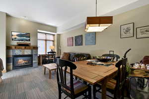 Carpeted dining room featuring a fireplace