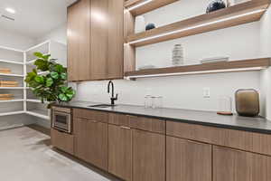 Bar with visible vents and a sink