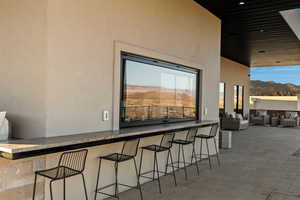 View of patio featuring a mountain view, outdoor dry bar, and an outdoor hangout area