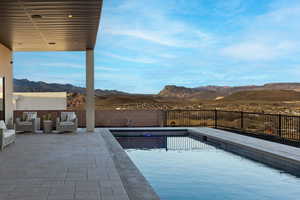 View of swimming pool with a patio area, a fenced backyard, a mountain view, and a fenced in pool