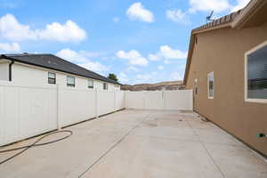 View of patio / terrace with a mountain view, fence, and a gate