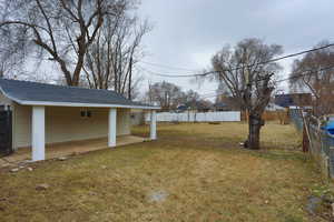 View of yard featuring a patio area and fence