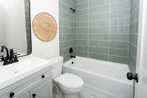 Full bath featuring shower / bathing tub combination, vanity, and toilet