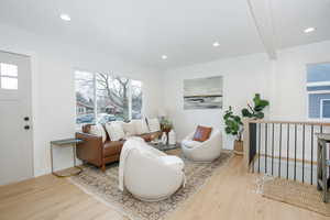 Living area with baseboards, wood finished floors, and recessed lighting