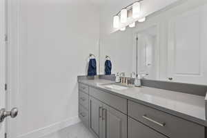 Bathroom featuring vanity and baseboards