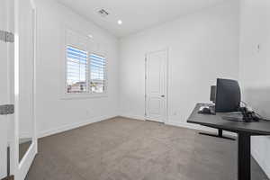 Carpeted office space featuring recessed lighting, visible vents, and baseboards