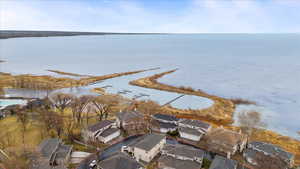 Birds eye view of property featuring a water view and a residential view