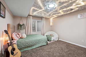 Carpeted bedroom with baseboards
