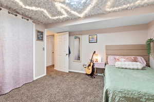 Carpeted bedroom featuring baseboards
