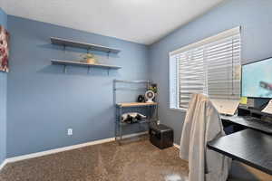 Carpeted office featuring baseboards