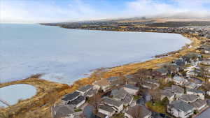 Birds eye view of property featuring a water view and a residential view