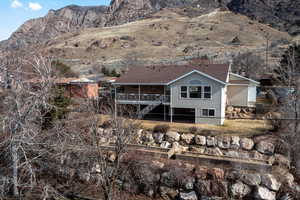 Rear view of property featuring a deck with mountain view