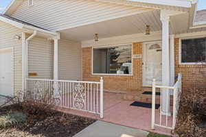 Entrance to property featuring a porch