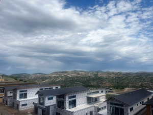 Rear view of property featuring Jordanelle Reservoir and Mountain view