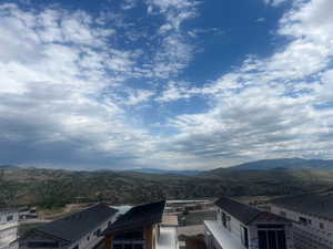 Rear view of property featuring Jordanelle Reservoir and Mountain view