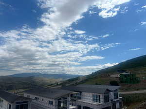 Rear view of property featuring Jordanelle Reservoir and Mountain view