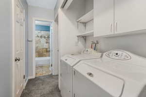 Laundry area with independent washer and dryer and cabinet space