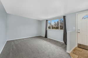 Living room features newer carpeting and large picture window