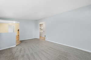 Living room features newer carpet and large picture window