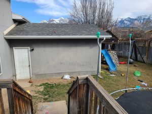 View of yard featuring a playground, fence, and a mountain view