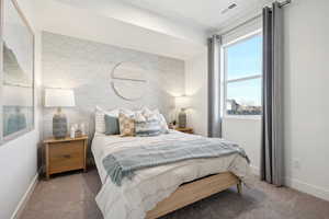 Bedroom featuring carpet, visible vents, baseboards, and wallpapered walls