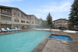 Community pool with fence and a patio