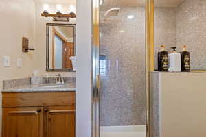 Bathroom featuring a stall shower and vanity