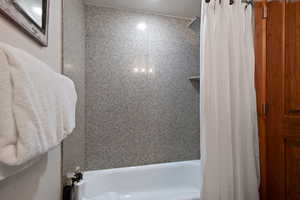 Bathroom featuring shower / bath combo with shower curtain