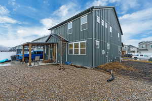Back of property with central AC unit and board and batten siding