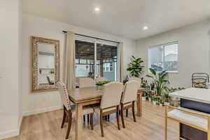 Dining area with light wood finished floors, recessed lighting, and baseboards