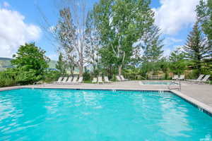 Pool featuring fence, a mountain view, and a patio