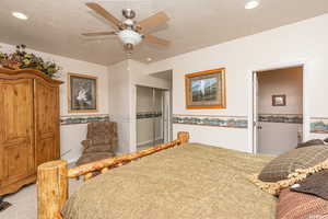 Bedroom featuring a textured ceiling, recessed lighting, light carpet, a ceiling fan, and a closet