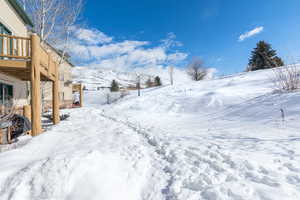 Yard layered in snow with a garage