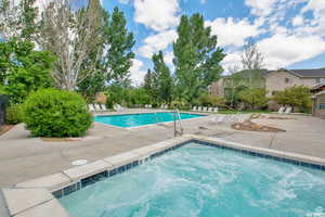 Community pool with a patio