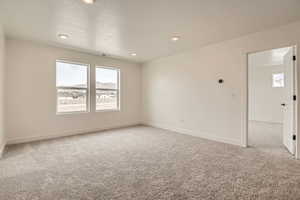 Loft with recessed lighting, baseboards, visible vents, and carpet floors