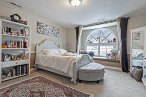 Bedroom with light carpet, baseboards, and visible vents