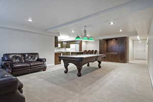 Playroom with recessed lighting, light colored carpet, billiards, and a textured ceiling