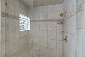 Bathroom featuring tiled shower