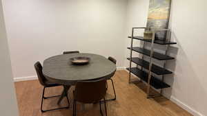 Dining room featuring light wood-style flooring and baseboards