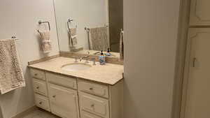 Bathroom featuring vanity and tile floors