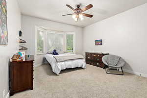 Bedroom featuring carpet flooring, ceiling fan, and baseboards