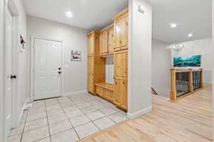 Mudroom featuring recessed lighting, light wood-style flooring, and baseboards