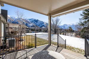 Wooden deck with central AC unit and a mountain view