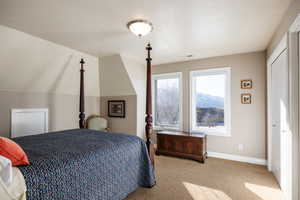 Carpeted bedroom featuring baseboards and visible vents