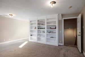 Unfurnishednoffice  featuring visible vents, baseboards, and carpet flooring