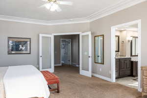 Bedroom featuring visible vents, baseboards, light colored carpet, crown molding, and french doors