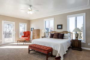 Carpeted bedroom with ceiling fan, access to outside, ornamental molding, and baseboards