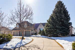 View of front of property featuring concrete driveway and brick siding