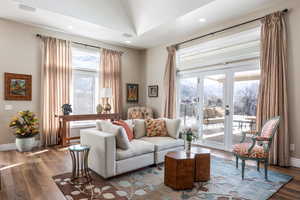 Family room with french doors, visible vents, baseboards, and wood finished floors