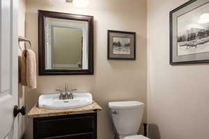 1/2 Bathroom featuring toilet and vanity